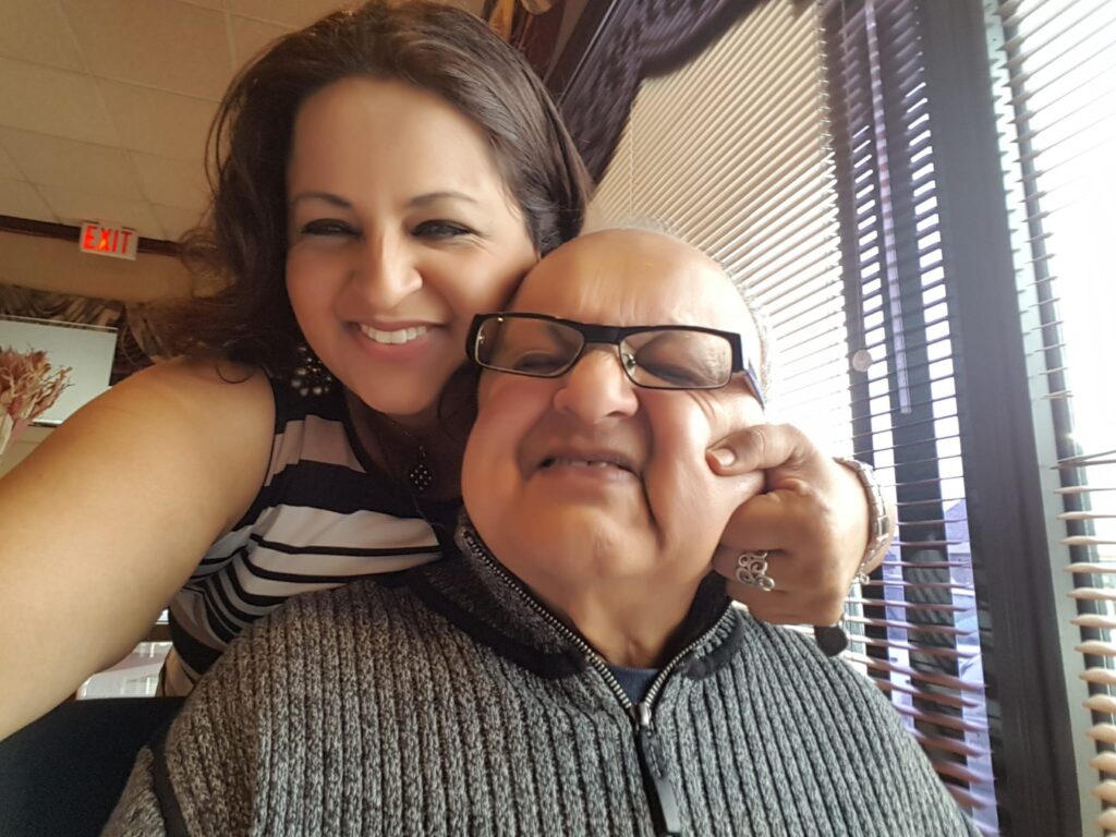 Zafira pinching her late father's cheek